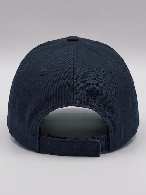 Back of the navy cap with the adjustable hook-and-loop strap