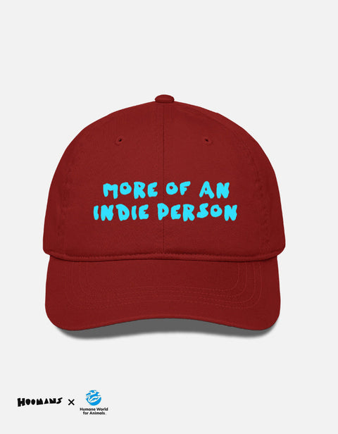 More Of An Indie Person red cotton cap with the slogan embroidered in blue on the front panel, Hoomans x Humane World for Animals India lockup