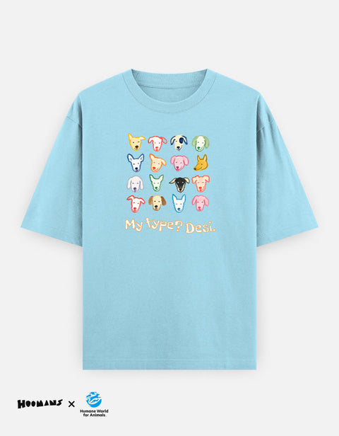 My Type? Desi Light oversized tee in baby blue, sixteen painted indie dog faces above My type? Desi. lettering, Hoomans x Humane World for Animals India lockup