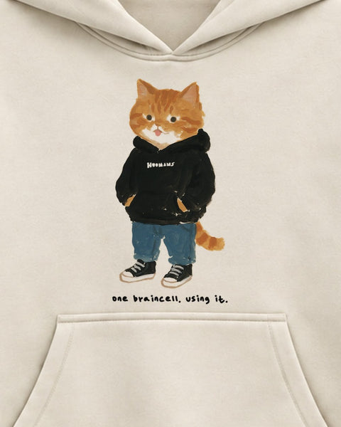 Close up of the chest print: a ginger tabby in a black HOOMANS hoodie with its tongue out above 'one braincell. using it.'