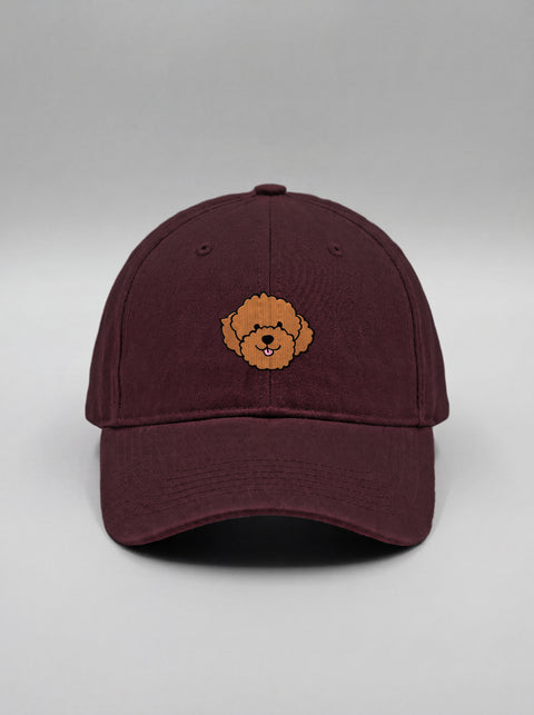 Maroon baseball cap with embroidered poodle face, front view