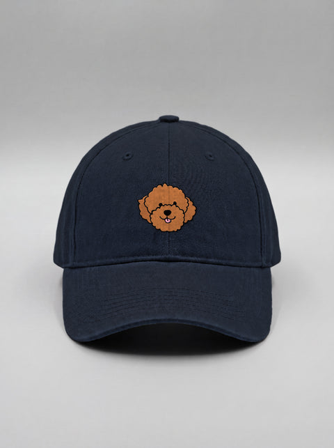Navy blue baseball cap with embroidered poodle face, front view