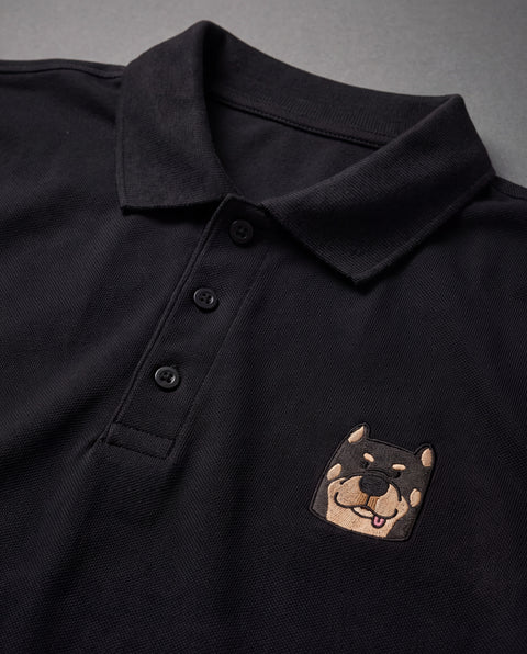 Black embroidered Rottweiler polo, close-up of collar, button placket, and satin-stitch chest patch