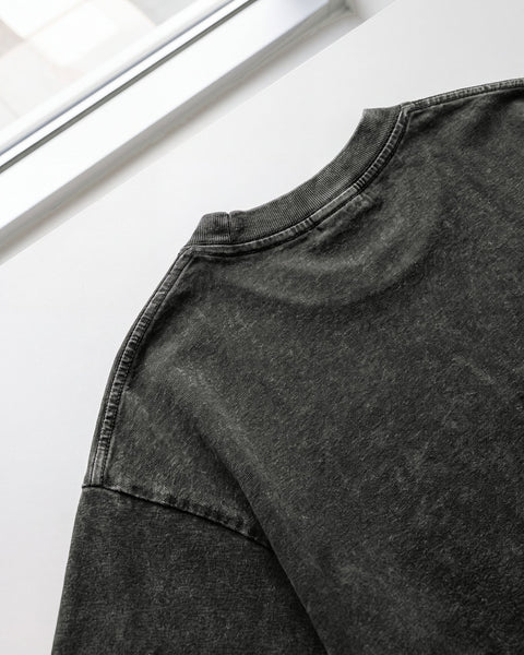 Back neckline and drop shoulder of the washed black vintage wash tee
