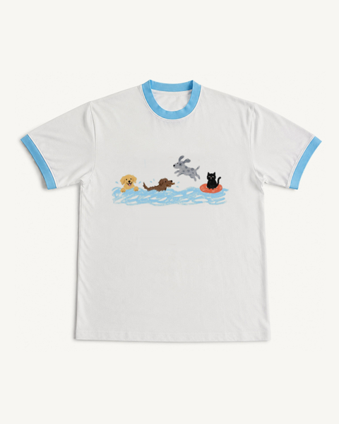 White ringer tee with sky blue trims and a crayon drawing of three dogs swimming and a black cat on a swim ring, front flat lay