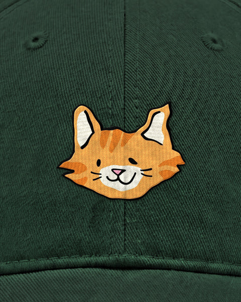 Embroidered orange tabby cat face in satin stitch on a bottle green baseball cap, close up