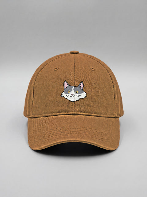 Khaki baseball cap with embroidered white and grey cat face, front view