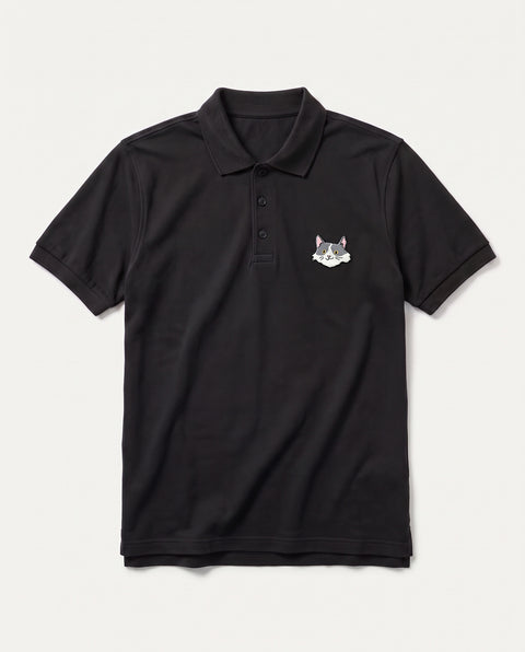 Black polo shirt with embroidered white and grey cat face on the chest, front flat lay