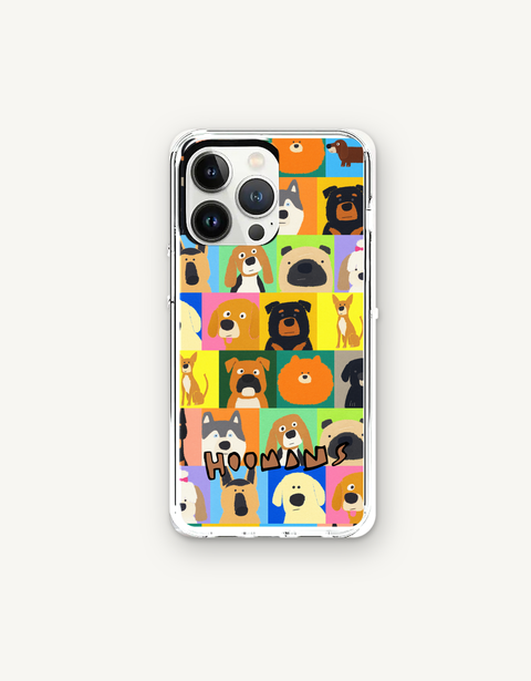 Hoomans Lotta Dogs iPhone case: colour-block grid of hand-drawn dog breed portraits with HOOMANS lettering, flat lay on off-white, iPhone 13 Pro mockup
