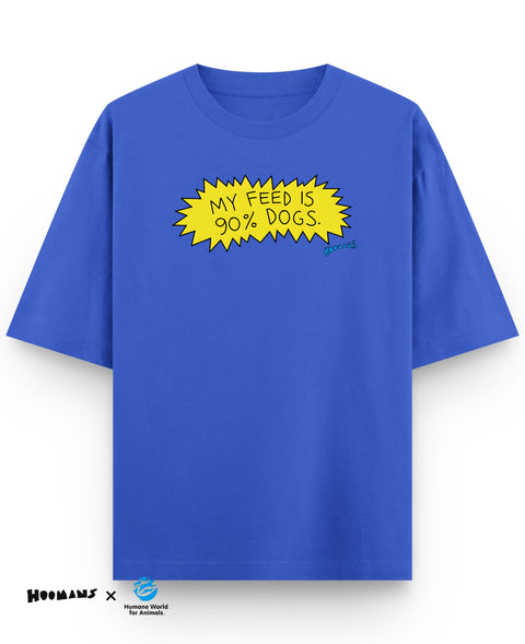 Royal blue oversized tee with 'My feed is 90% dogs.' hand lettered in a yellow comic burst, front view, Hoomans x Humane World for Animals lockup