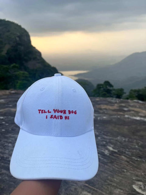Tell Your Dog I Said Hi white cap held up against the hills, real customer photo, Hoomans India