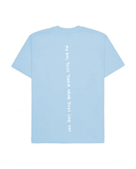 Baby blue oversized tee with 'My Dog Tilts Their Head Just Like You' white puff print, back flat lay