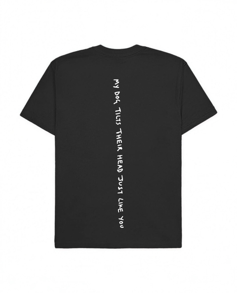 Black oversized tee with 'My Dog Tilts Their Head Just Like You' white puff print, back flat lay